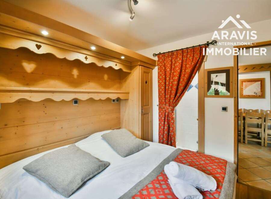 Discover the charm of this cozy bedroom, featuring a beautifully crafted wooden headboard and accents.