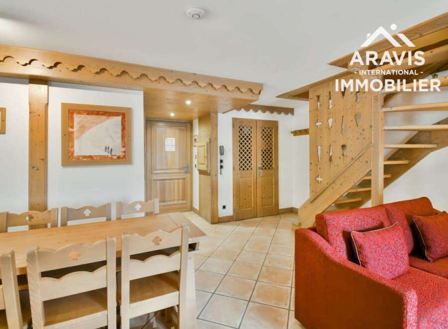 Discover this charming property featuring a cozy living space with a comfortable red sofa, perfect for relaxation.