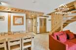 Discover this charming property featuring a cozy living space with a comfortable red sofa, perfect for relaxation.