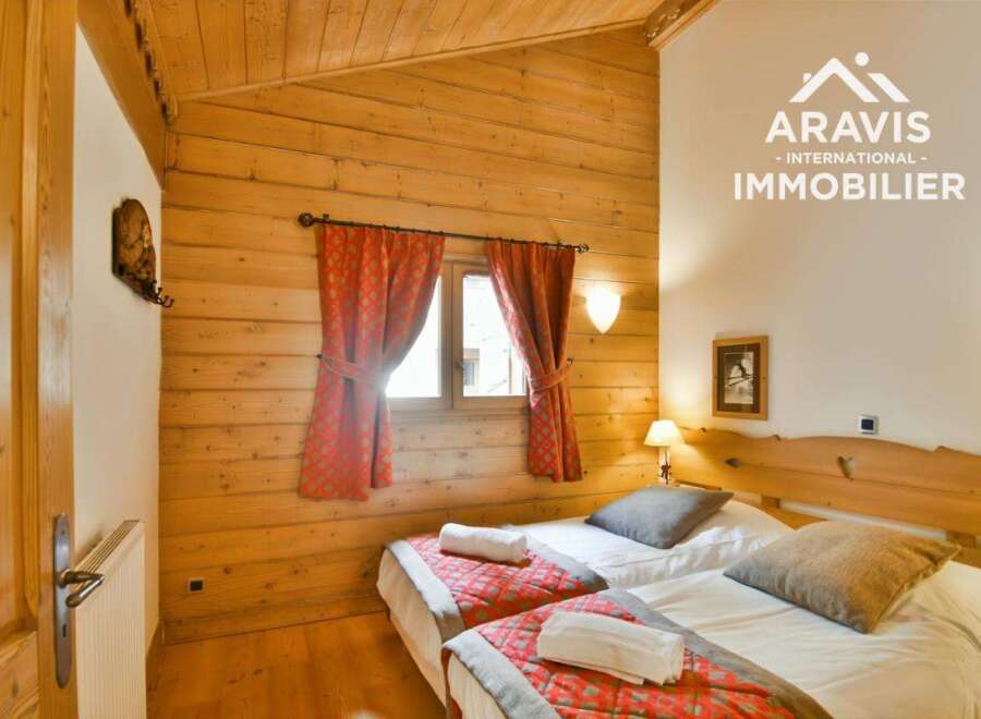 Discover the charm of this cozy bedroom featuring a rustic wooden interior and a welcoming ambiance.