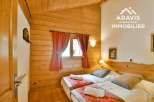Discover the charm of this cozy bedroom featuring a rustic wooden interior and a welcoming ambiance.