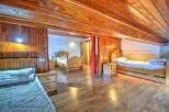 This charming property boasts a warm and inviting interior with beautiful wooden accents throughout.