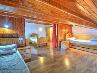 This charming property boasts a warm and inviting interior with beautiful wooden accents throughout.