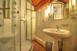 Step into this inviting bathroom, featuring a modern shower and a stylish pedestal sink.