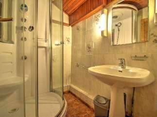 Step into this inviting bathroom, featuring a modern shower and a stylish pedestal sink.
