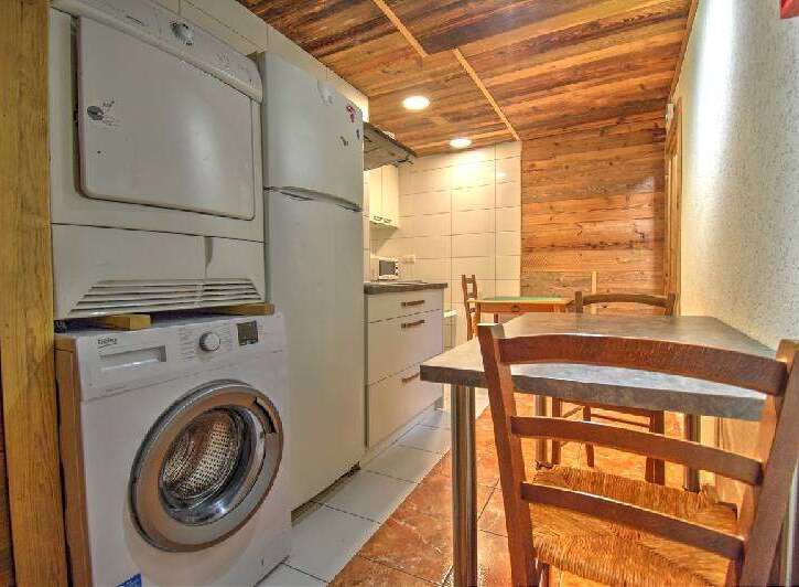 Discover this charming property featuring a well-equipped kitchen with modern appliances, including a washing machine and dryer.