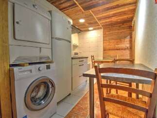 Discover this charming property featuring a well-equipped kitchen with modern appliances, including a washing machine and dryer.