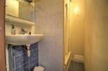 Discover this charming bathroom featuring a pristine white sink and a convenient shower area.
