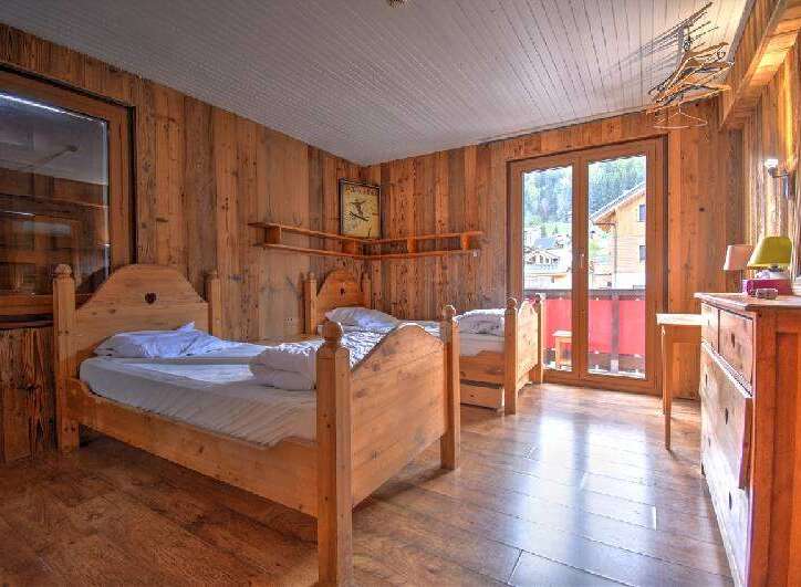 This charming bedroom features a rustic wooden design, creating a warm and inviting atmosphere.