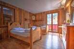 This charming bedroom features a rustic wooden design, creating a warm and inviting atmosphere.