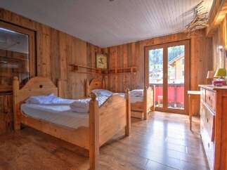 This charming bedroom features a rustic wooden design, creating a warm and inviting atmosphere.
