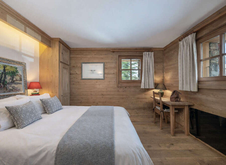 Experience the warmth and charm of this cozy bedroom, featuring stunning wood paneling that adds a touch of rustic elegance.