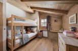 This charming bedroom features a cozy bunk bed, perfect for a children's room or a guest space.