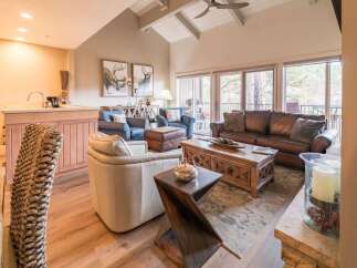 Step into luxury with this stunning living room, featuring a cozy leather sofa and inviting armchairs.