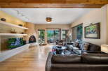 Step into luxury with this stunning living room, featuring a cozy fireplace and a large flat-screen TV.