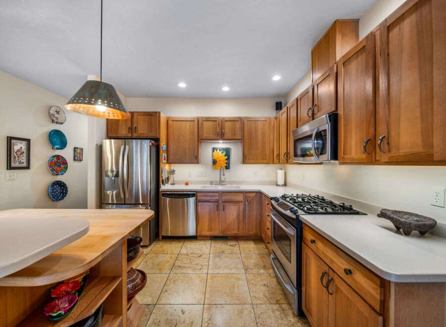 This stunning kitchen boasts beautiful wooden cabinetry and modern stainless steel appliances.