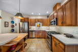This stunning kitchen boasts beautiful wooden cabinetry and modern stainless steel appliances.