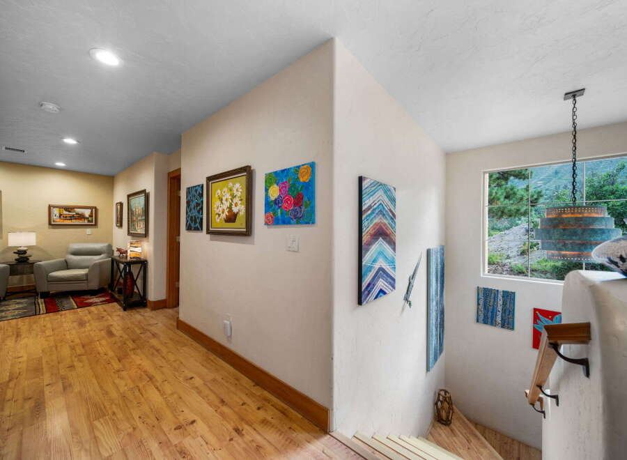 Step into this inviting home and be greeted by a stunning hallway adorned with beautiful artwork.