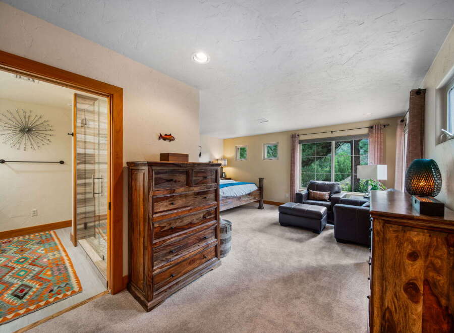 Step into luxury with this stunning bedroom, featuring exquisite wooden furniture and a spacious layout.