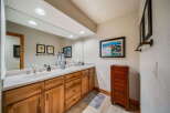 This stunning bathroom features a large mirror, double sinks, and ample cabinet space, perfect for a luxurious and functional space.