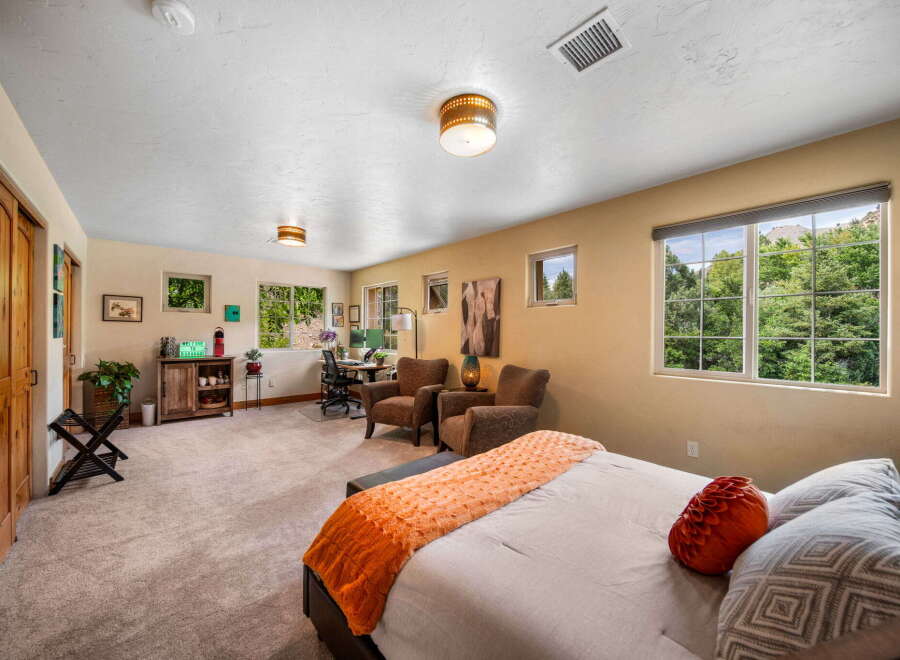 This spacious bedroom offers a comfortable retreat with ample natural light.