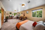 This spacious bedroom offers a comfortable retreat with ample natural light.