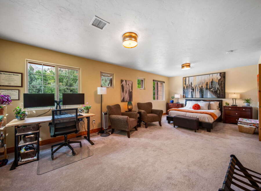 Step into this spacious and inviting bedroom, perfect for relaxation and productivity.