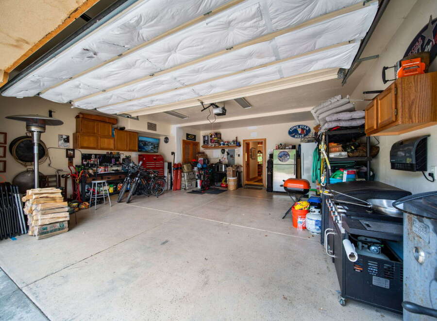This spacious garage offers ample storage and workspace, perfect for any homeowner.