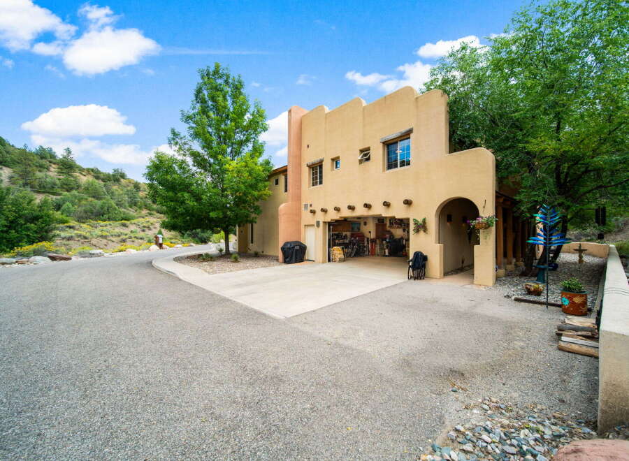 Discover this stunning property featuring a charming stucco exterior and a spacious driveway.