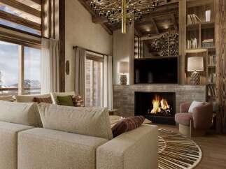 Experience luxury living in this stunning property, featuring a cozy fireplace and a modern entertainment setup.