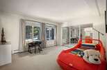 This charming bedroom features a unique red car-shaped bed, perfect for a child's room.
