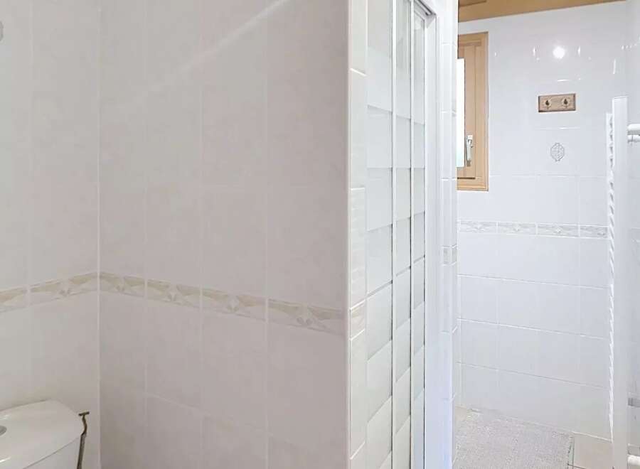 Step into this bright and airy bathroom, featuring a modern shower and a clean, minimalist design.