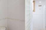 Step into this bright and airy bathroom, featuring a modern shower and a clean, minimalist design.