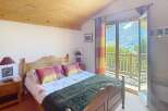 Discover a cozy bedroom with a stunning mountain view.