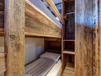 Discover the charm of this cozy bunk bed setup, perfect for maximizing space in a vacation home or rental property.
