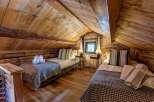 Discover the charm of this cozy bedroom, featuring rustic wooden accents and a warm, inviting atmosphere.