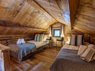 Discover the charm of this cozy bedroom, featuring rustic wooden accents and a warm, inviting atmosphere.