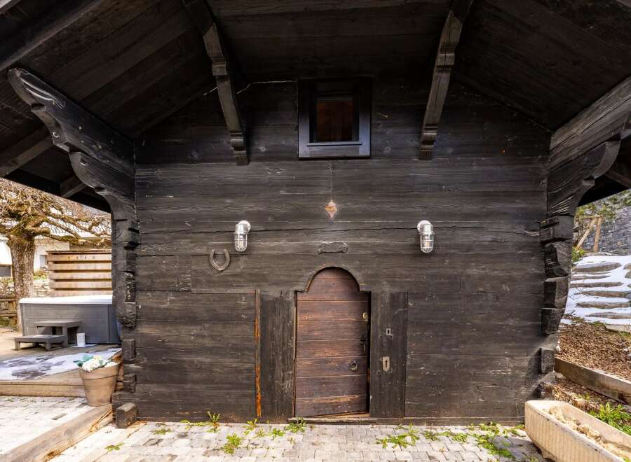 Discover the rustic charm of this unique property, featuring a beautifully crafted wooden facade.