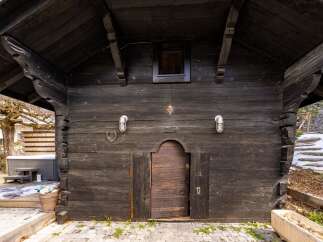 Discover the rustic charm of this unique property, featuring a beautifully crafted wooden facade.