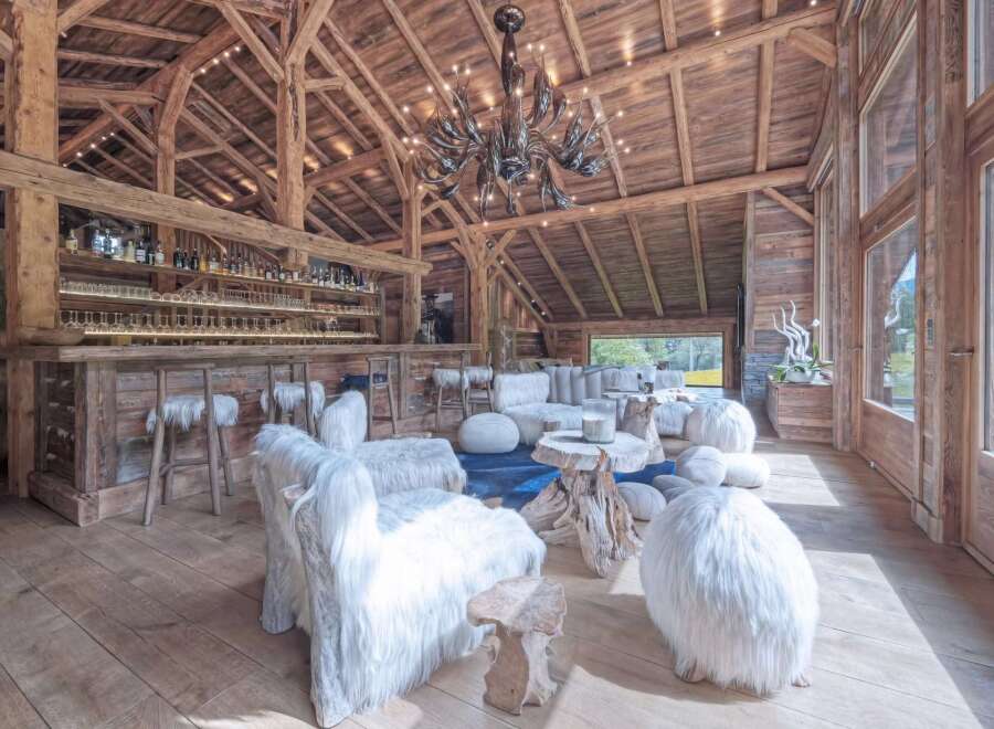Experience rustic luxury in this stunning chalet, featuring exposed wooden beams and a cozy ambiance.