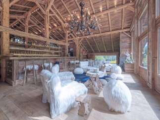 Experience rustic luxury in this stunning chalet, featuring exposed wooden beams and a cozy ambiance.