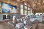 Experience luxury living in this stunning chalet, featuring a cozy fireplace and a large flat-screen TV perfect for relaxing after a day on the slopes.