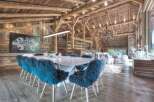 Experience luxury living in this stunning property featuring a spacious dining area with a modern marble table and stylish blue fur chairs.