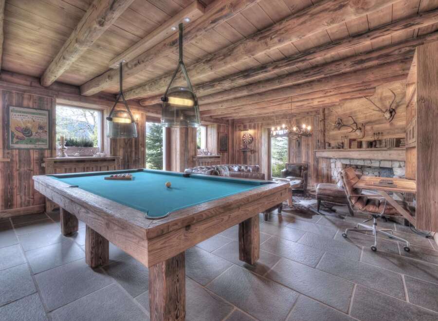 Step into luxury with this stunning property featuring a rustic game room.