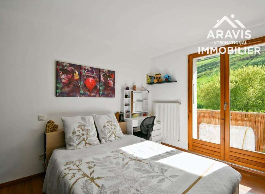 Discover this charming bedroom featuring a comfortable bed and a stylish desk area.