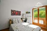 Discover this charming bedroom featuring a comfortable bed and a stylish desk area.