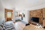 Discover this stunning property featuring a modern kitchen with sleek white cabinetry and stainless steel appliances.