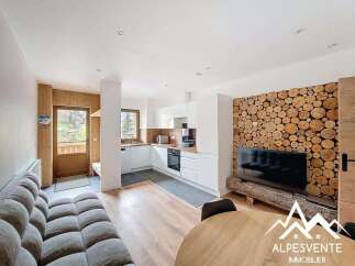Discover this stunning property featuring a modern kitchen with sleek white cabinetry and stainless steel appliances.