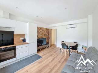Discover this modern apartment featuring a stylish kitchen with sleek white cabinetry and a built-in oven.