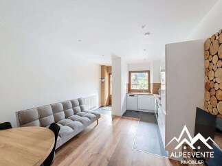 Discover this charming property featuring a cozy living space with a comfortable sofa and a dining area.